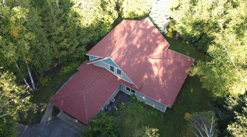 Aerial view of home with new CertainTeed Landmark PRO Red Oak shingle roof on Walloon Lake in Northern Michigan