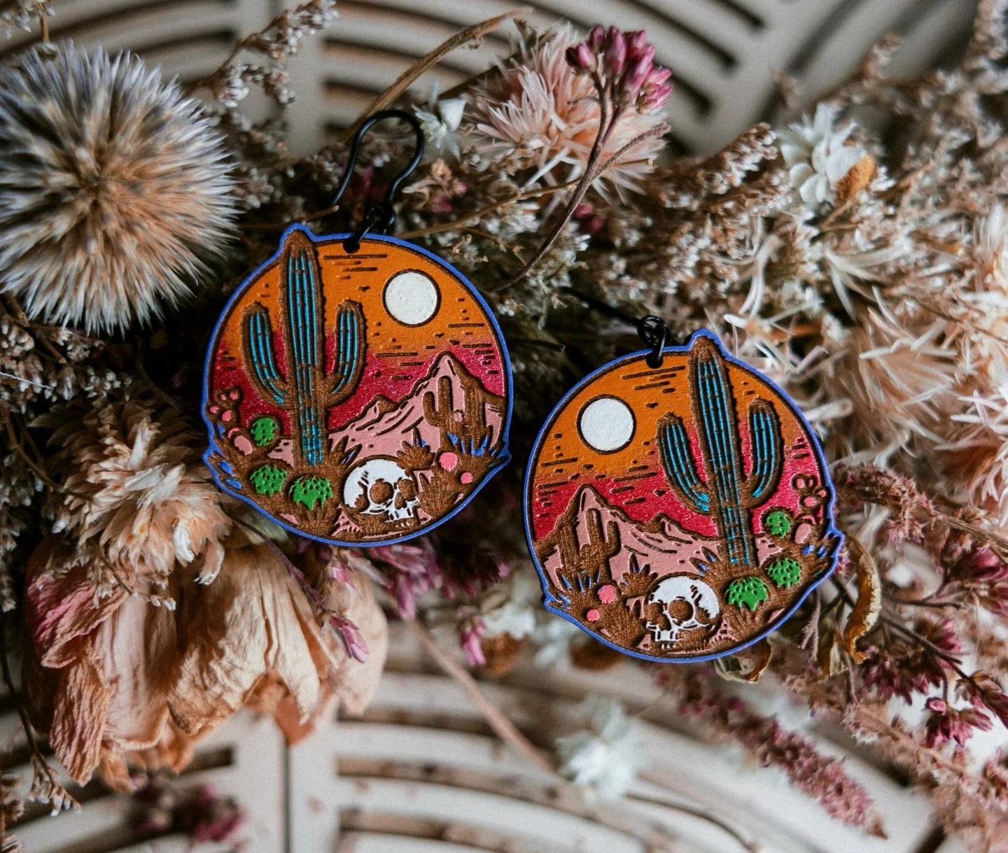 This beautiful landscape of death just sold! My one and only pair I ever made! So glad they found their home!!! 🌵💀🌅#uniqueearrings #statementearrings #bohostylejewelry #artistmade #handcraftedjewelry #smallbatchjewelry #jewelrydesigner #shophandma