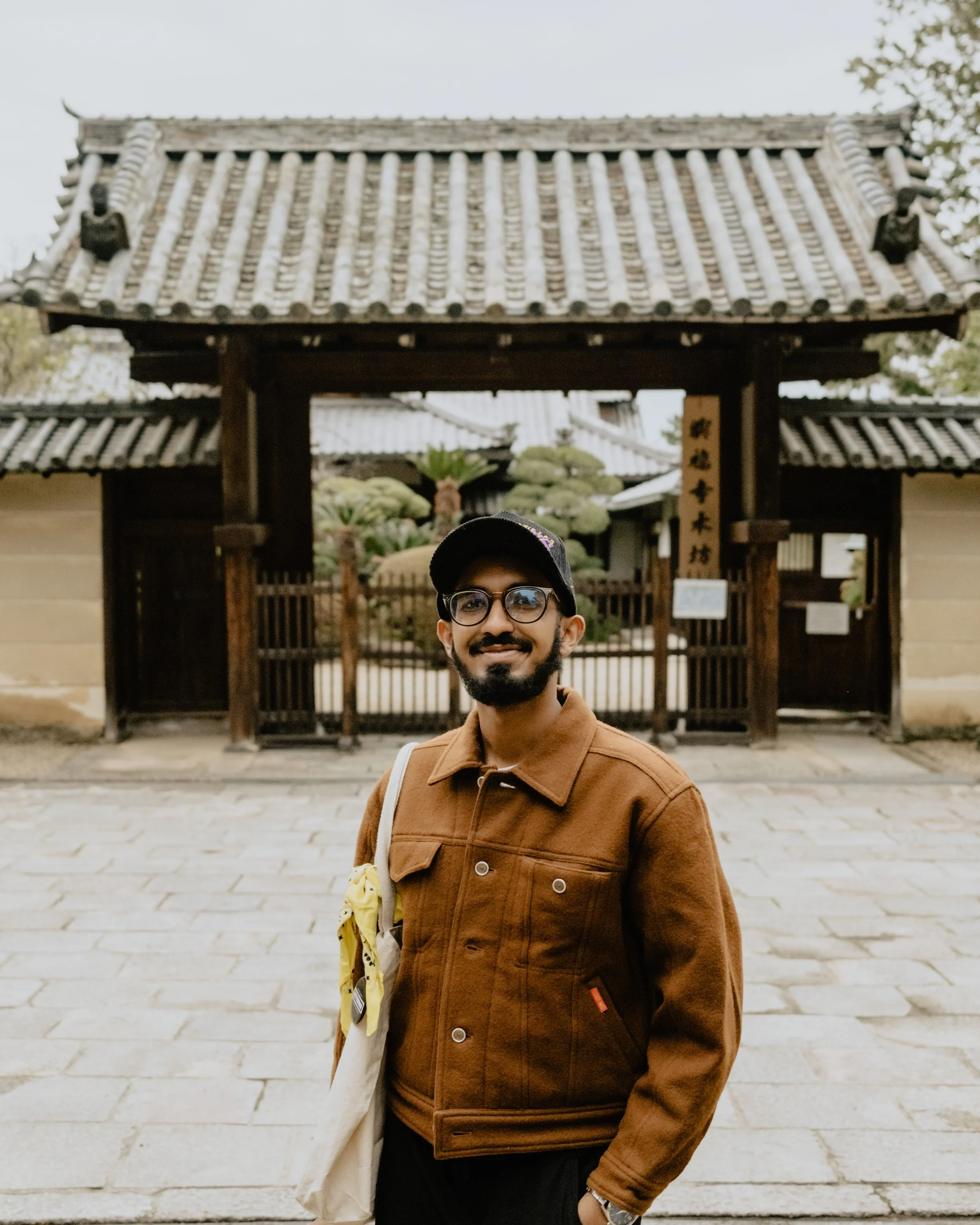 Portrait of a man standing in front of a Japanese Shrine