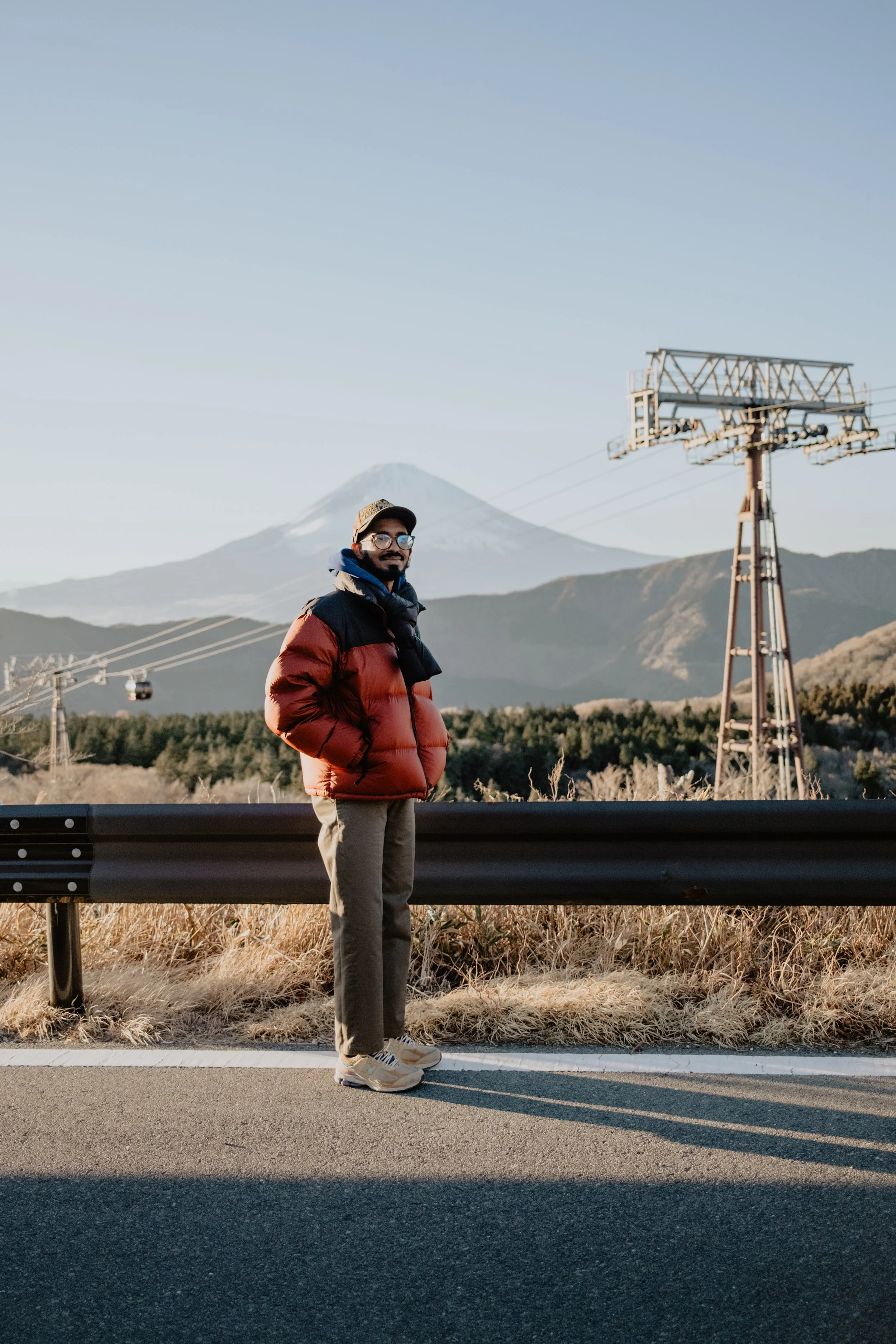 A man standing in front of Mount Fuji in Japan