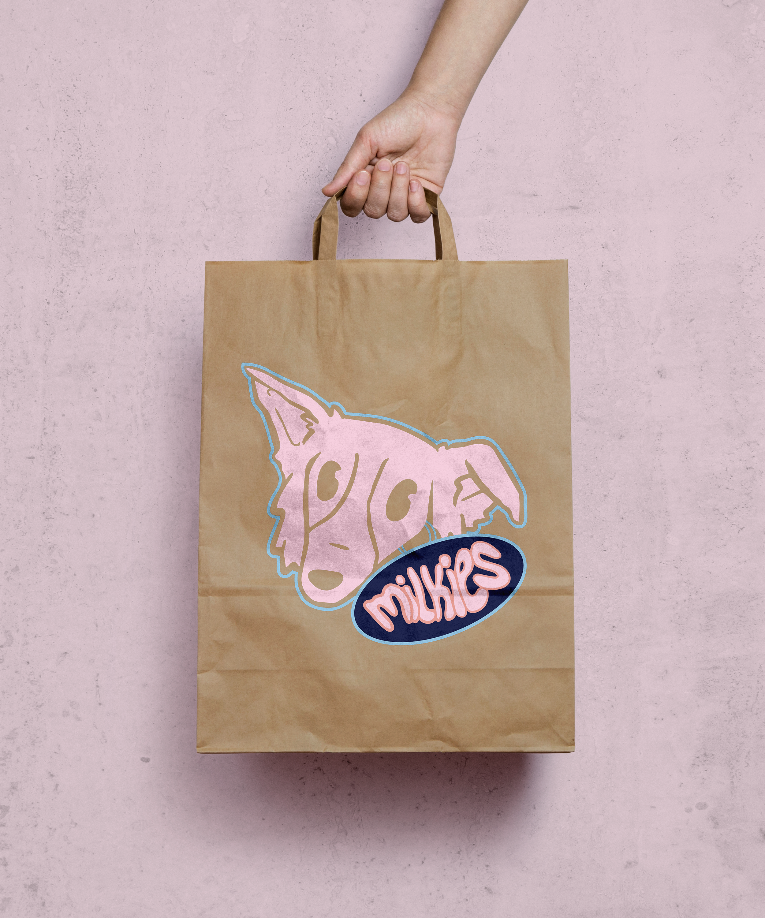 Brown paper bag with a pink dog illustration and the word 'milkies' on it, against a pinkish textured background.