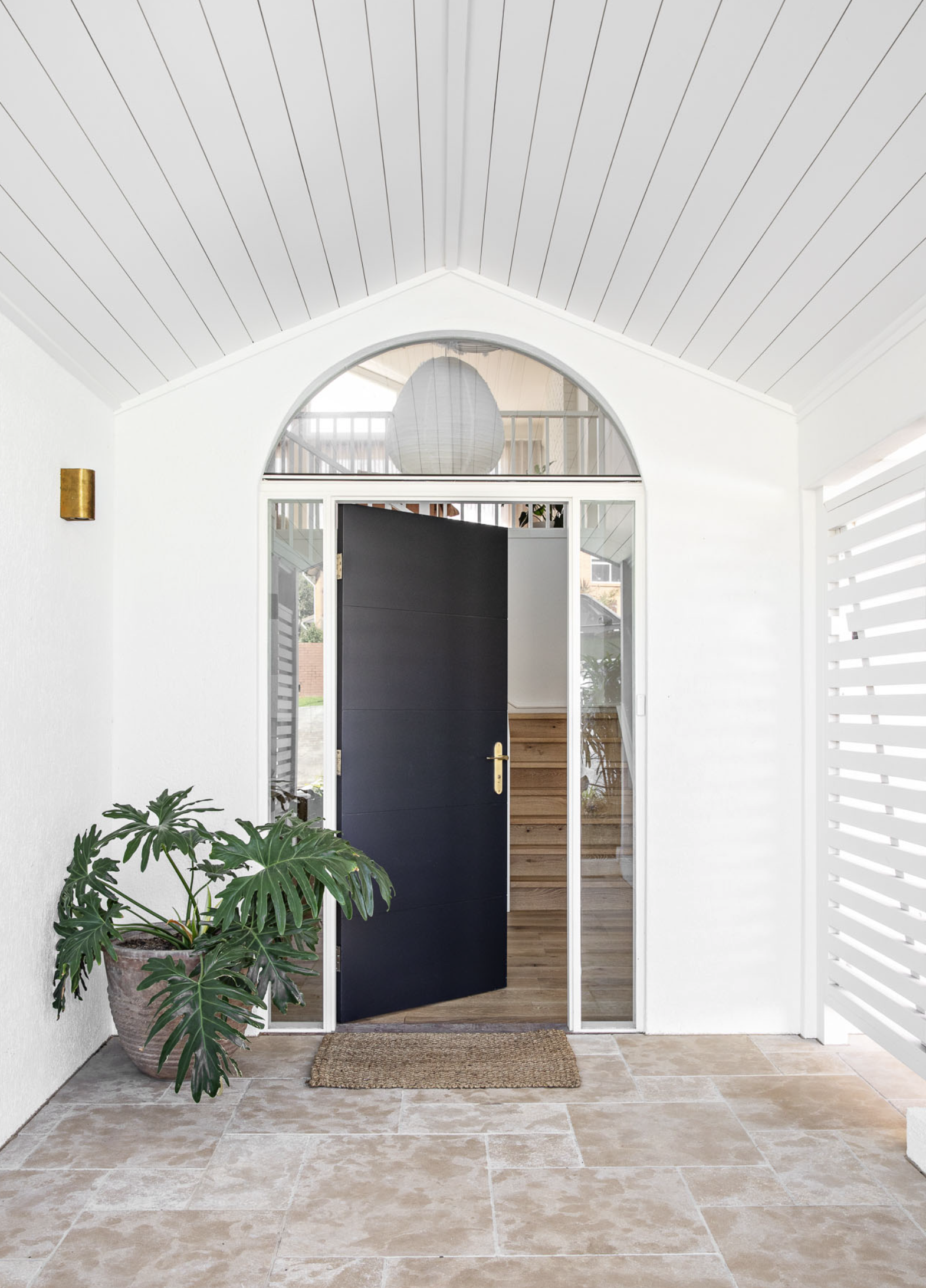 black front door of white coastal designer home