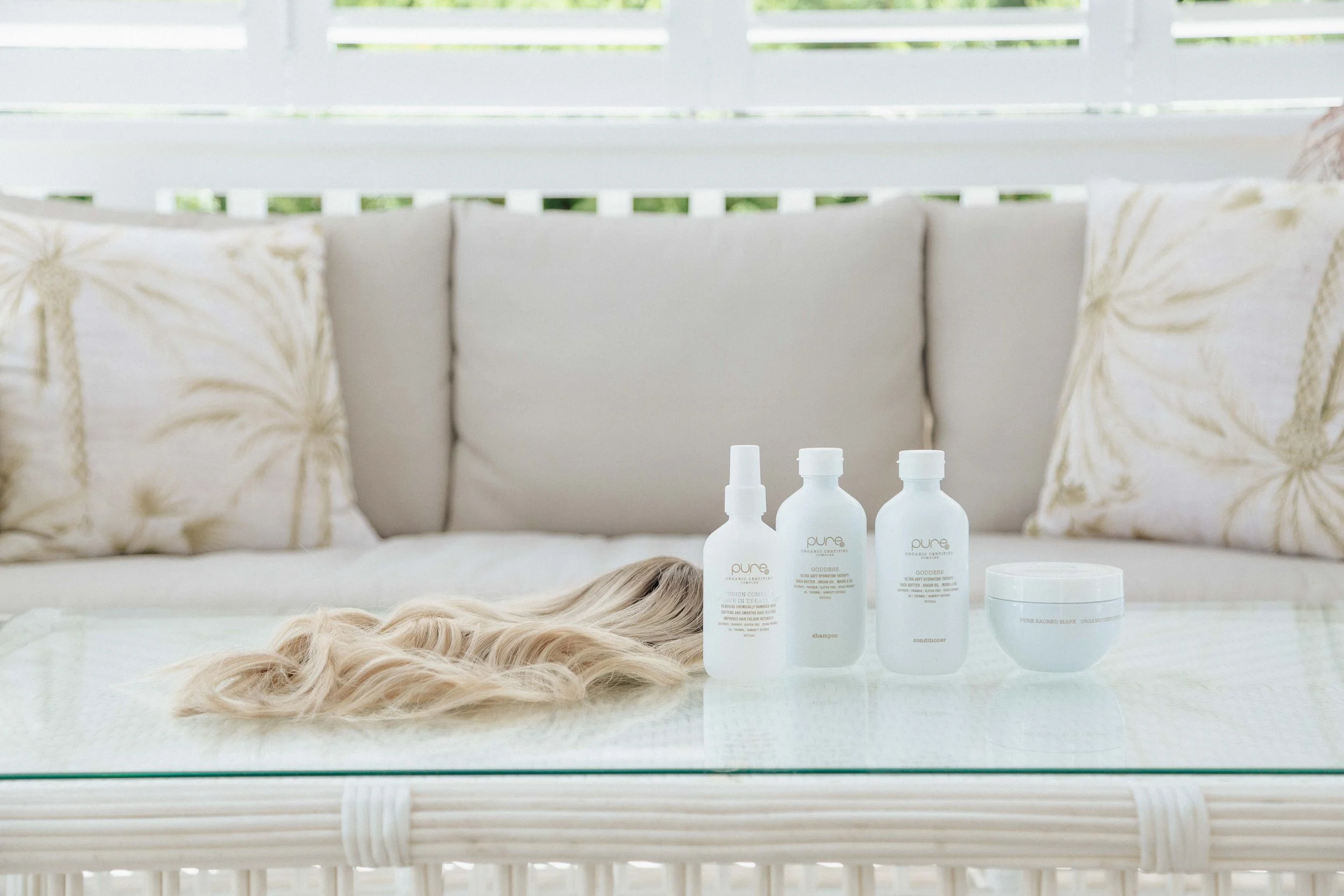 hair products with a blonde wig next to it on a table