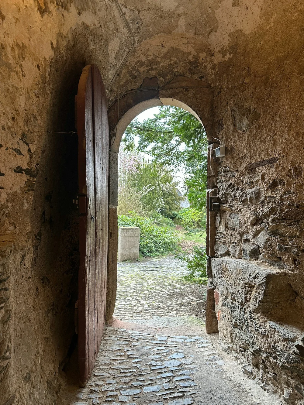 A stone archway opening onto a garden path