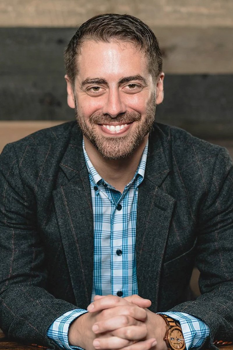 portrait of dr. clay brigance with his hands folded