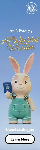 A cartoon rabbit in green overalls holds a U.S. passport with the text 'Your pass to a world of wonder' above. Below is a link to travel.state.gov and a 'Learn More' button. The U.S. Department of State seal is at the top.