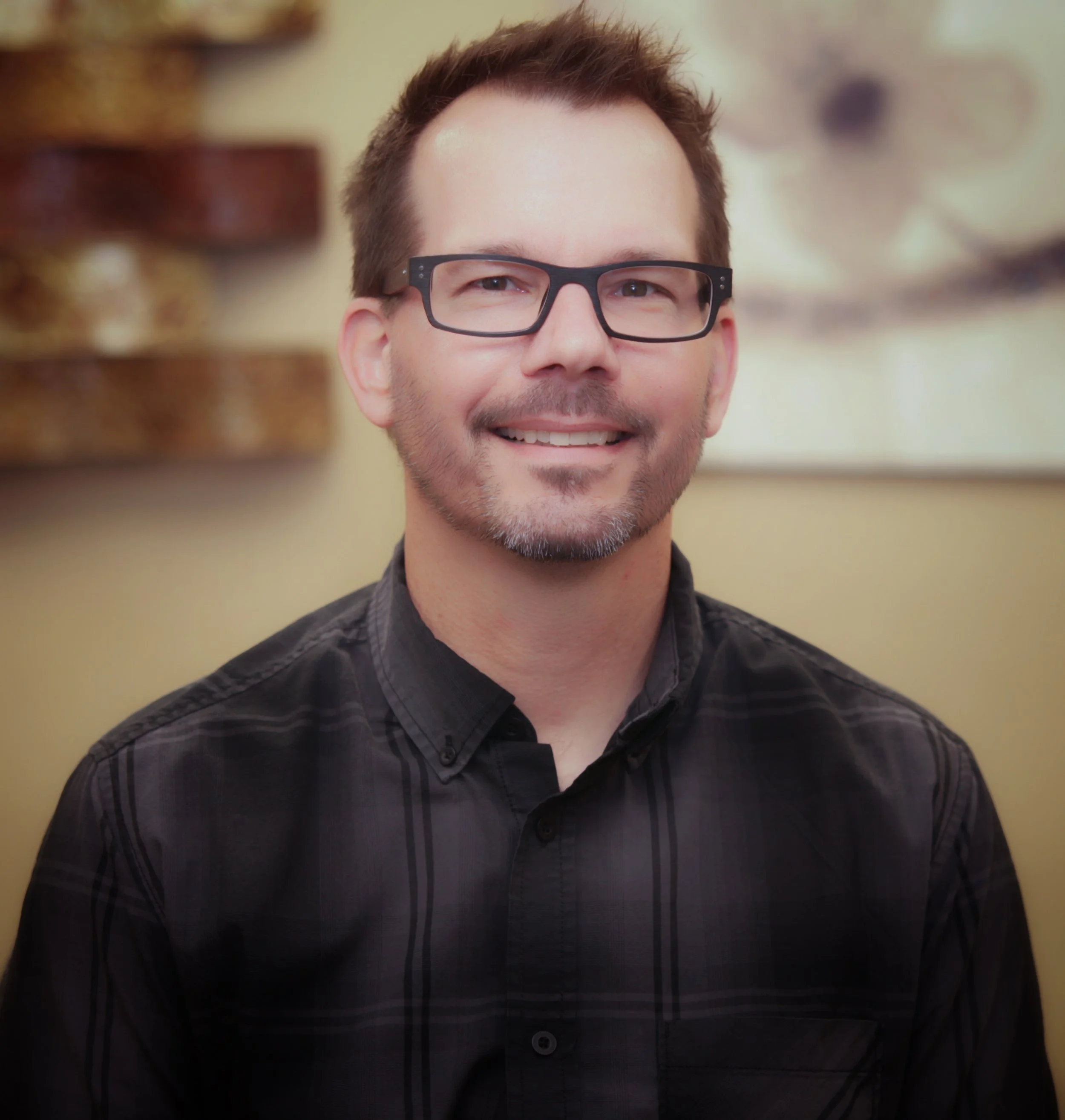 man in dark shirt and glasses