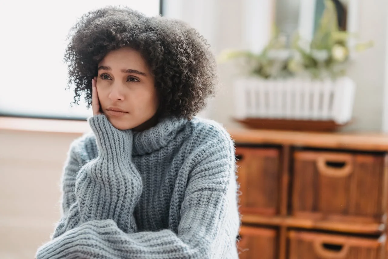 depressed-black-woman-sitting-in-room