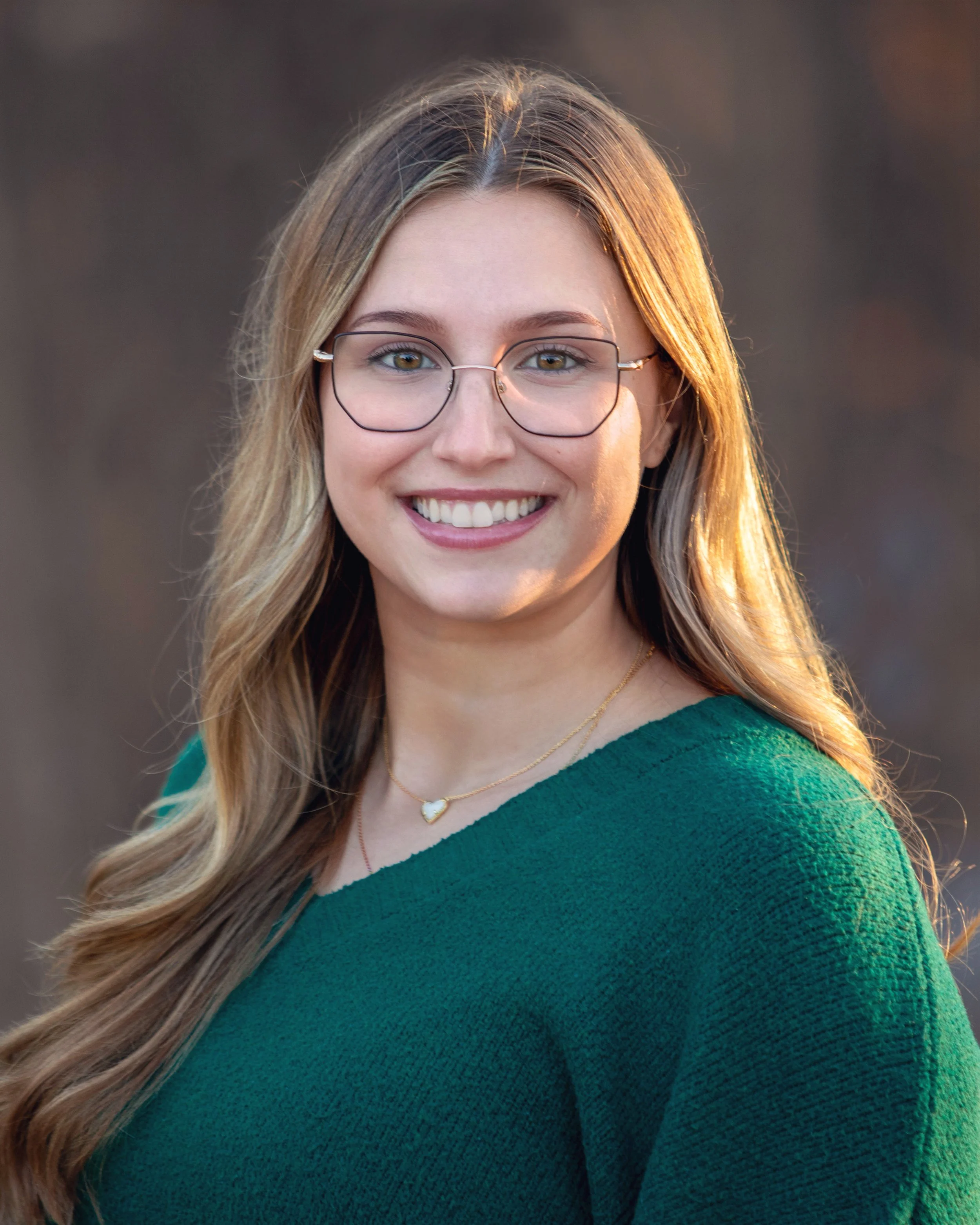 woman in glasses and green top