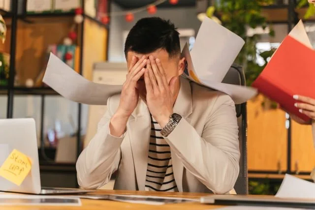 man with hands over face