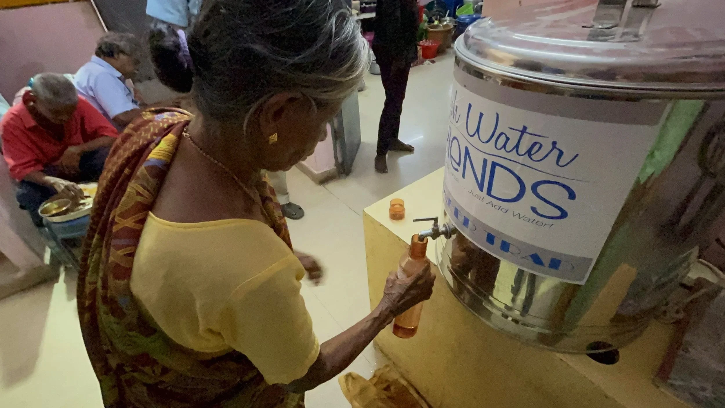 A woman fills a bottle of water