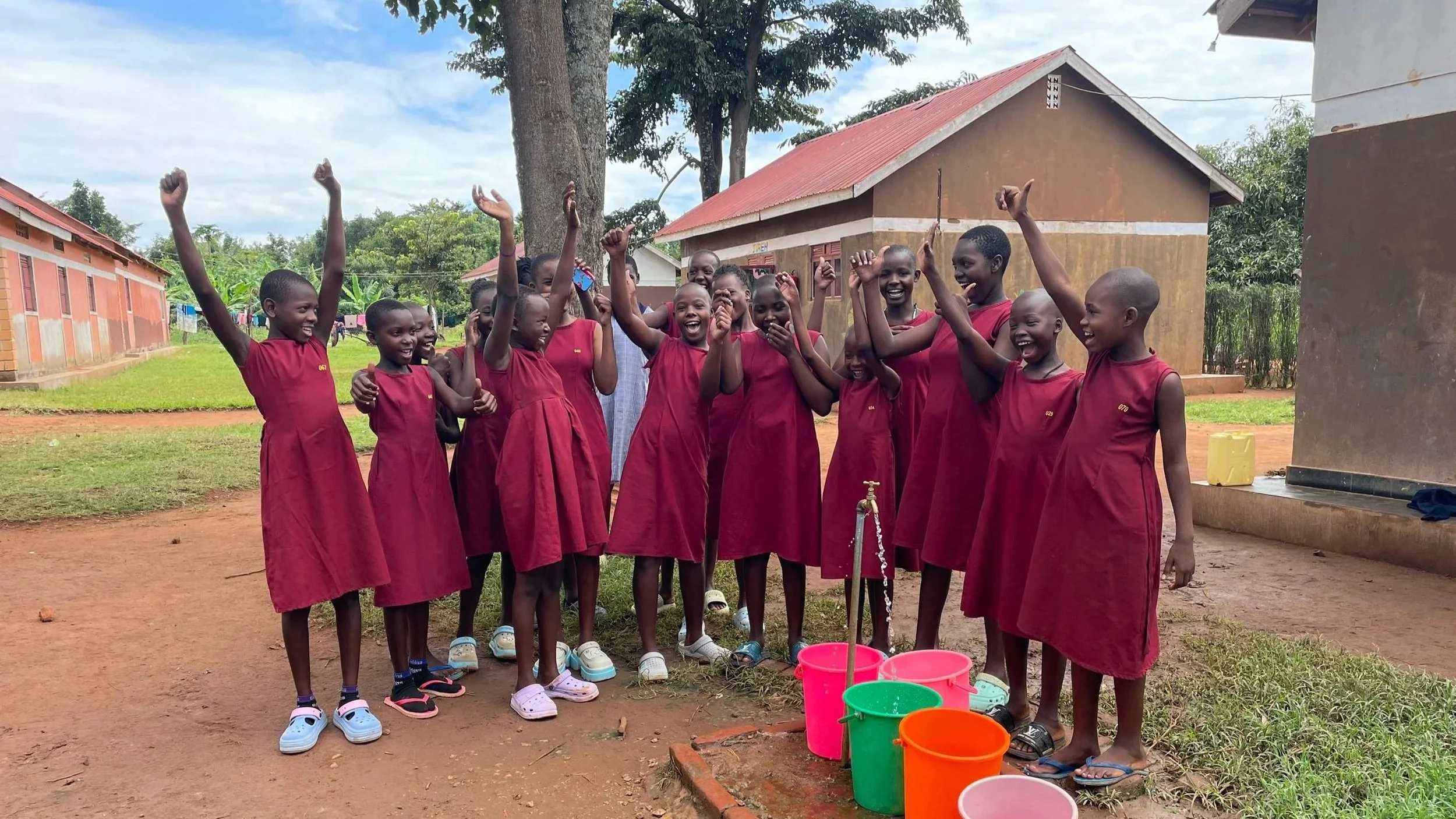 Girls cheer for their new water tap