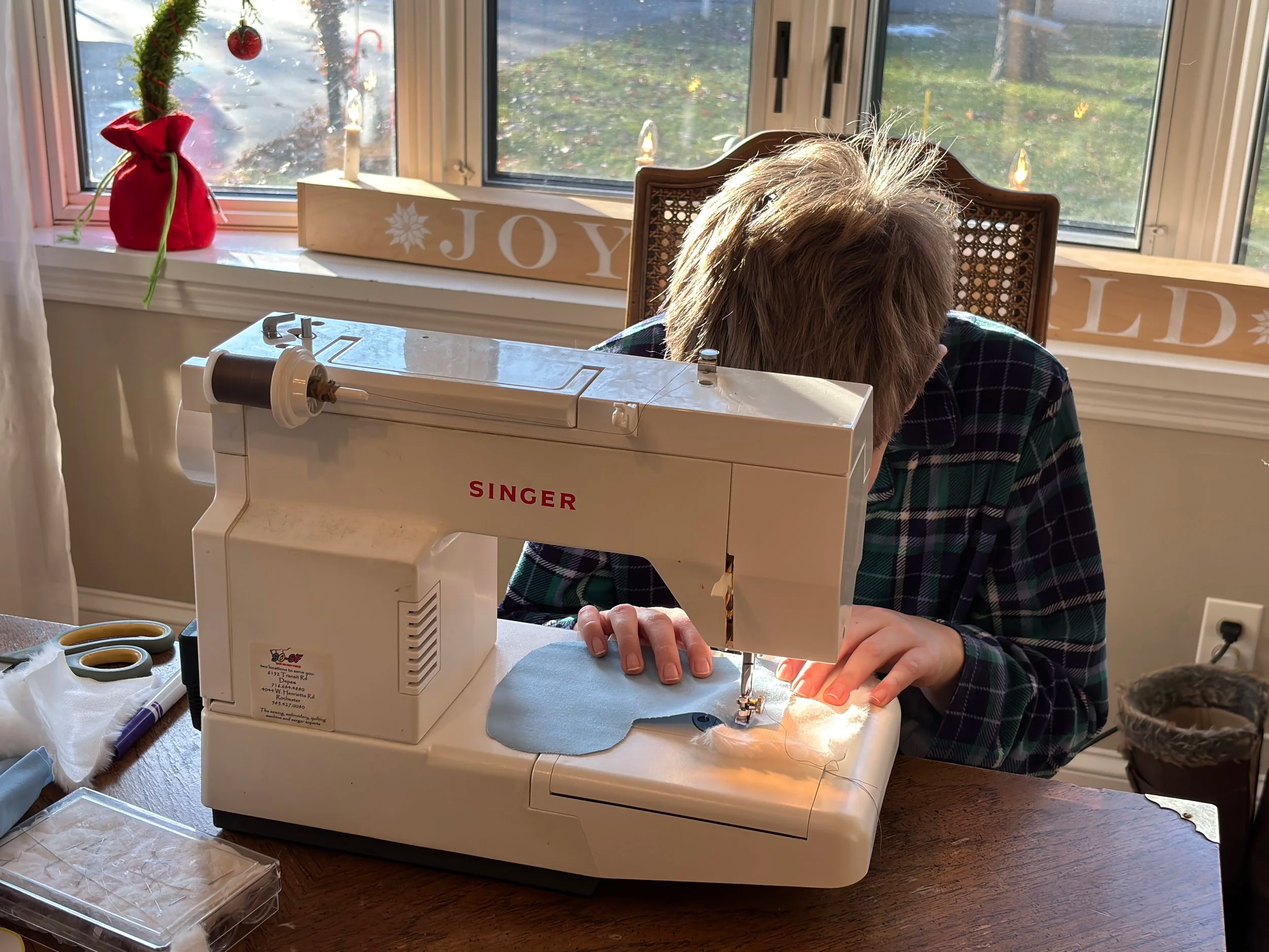 A child sews minisature stockings