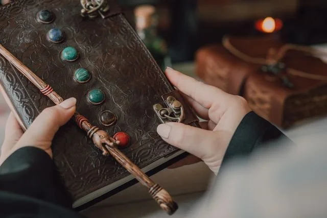 Leather journal being held in someone's hands