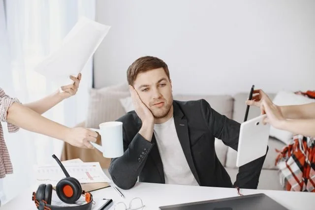 a man that is distracted about what is going on around him