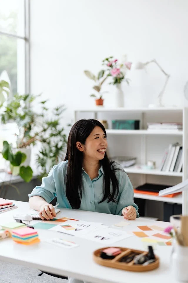 a person at a desk and smiling