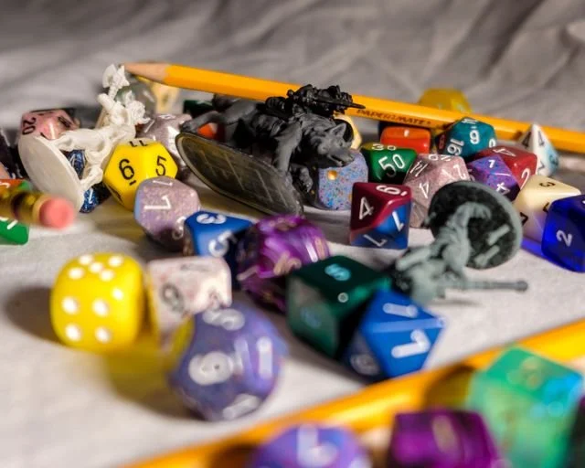 role playing dice, pencils and figurines
