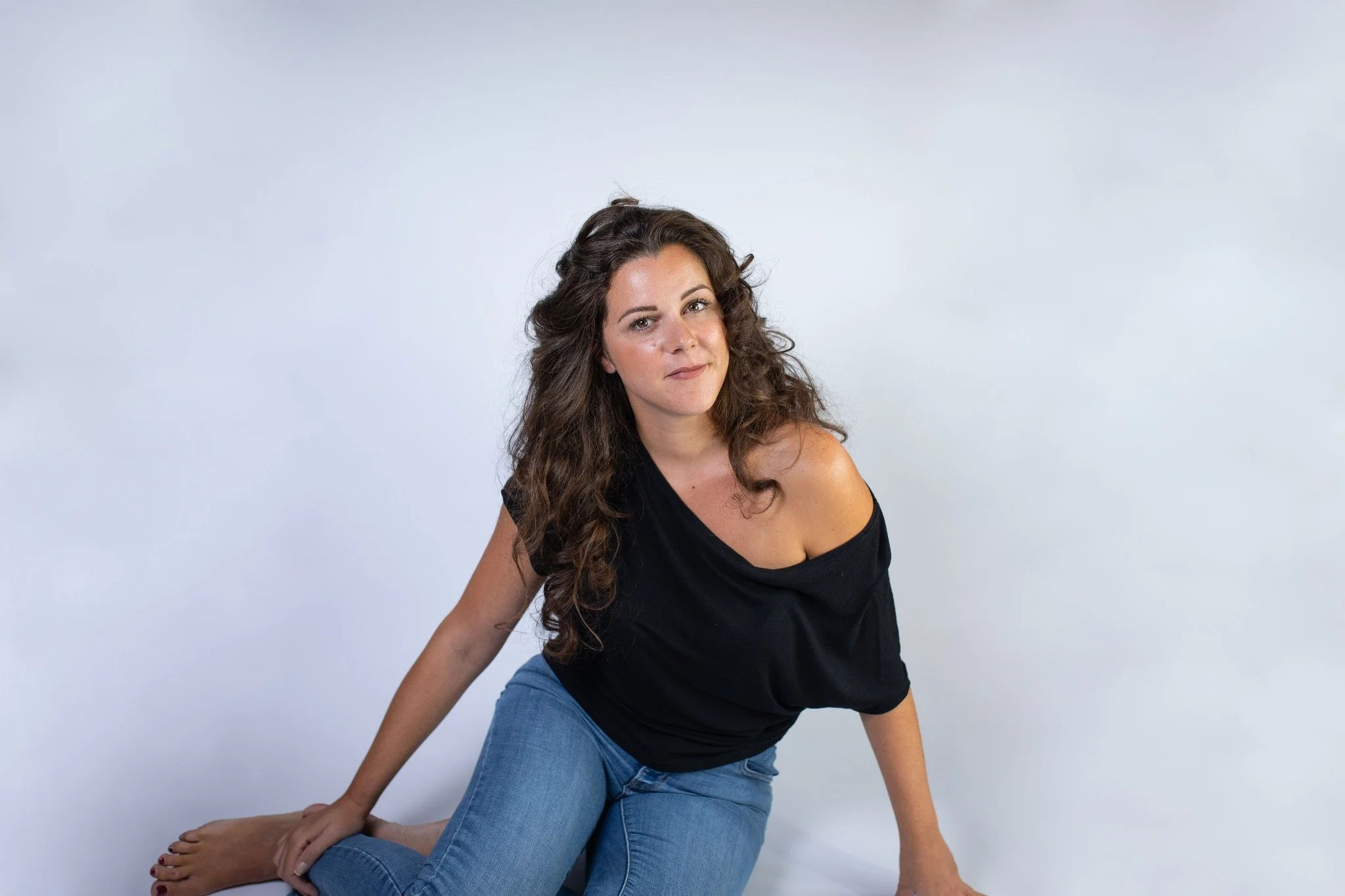 Michela Donazzan seated in a black top and jeans