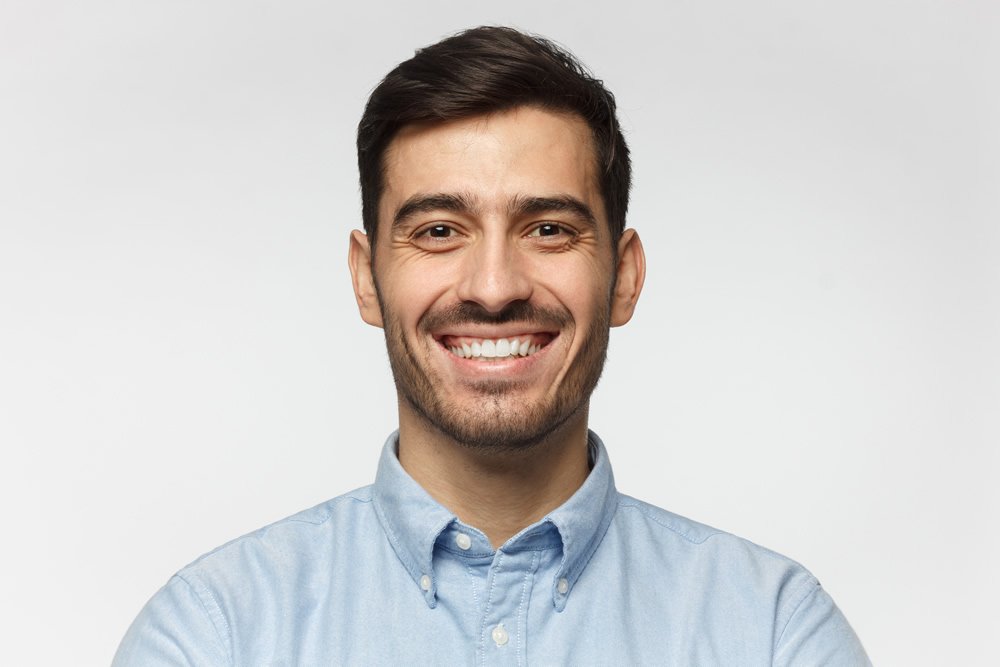 Light grey to white backdrop and natural side lighting.