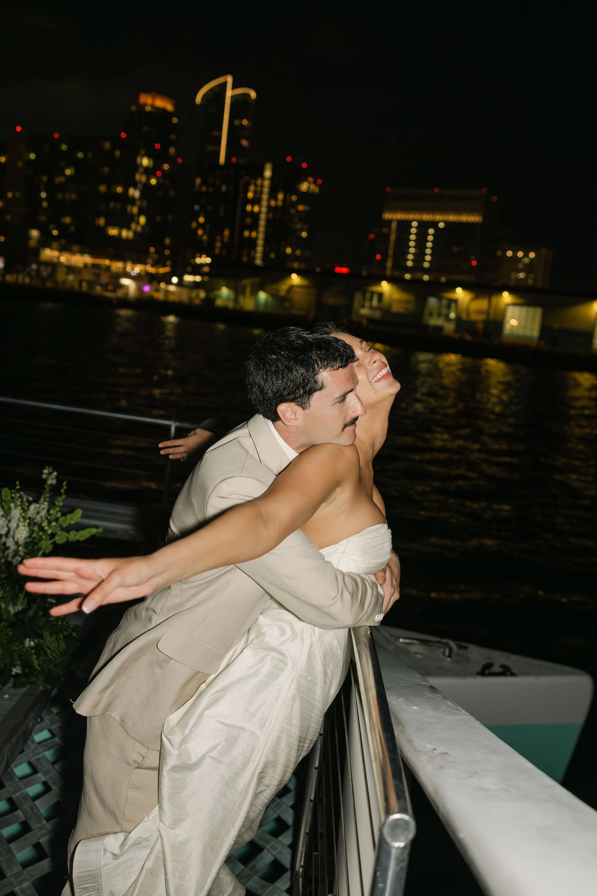 Newlywed couple embracing on yacht, nighttime, in san Diego california