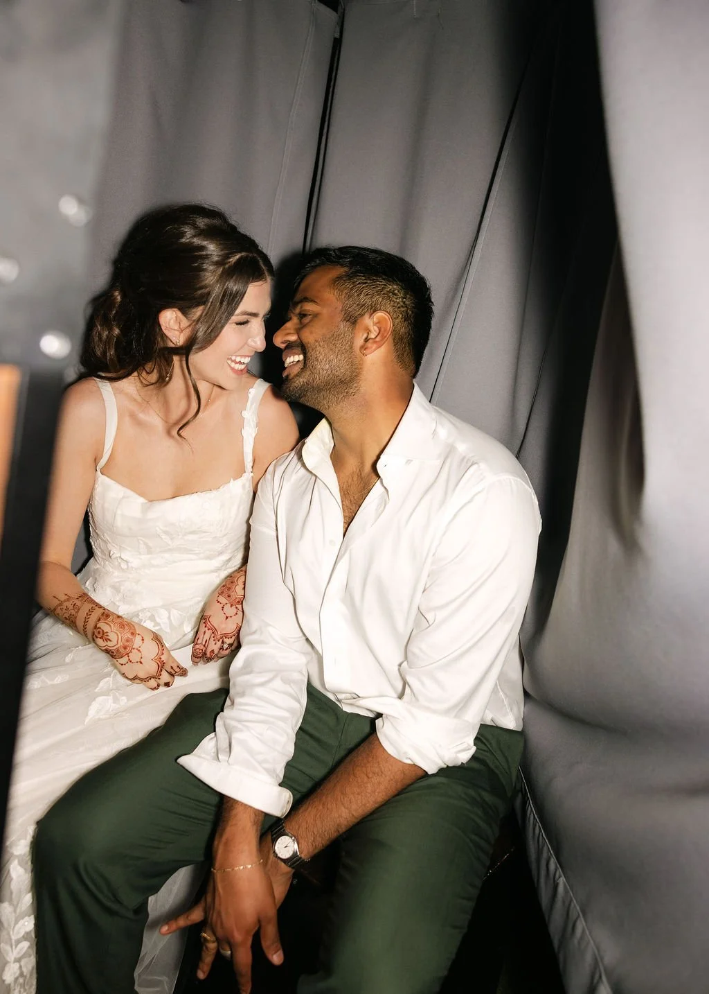 Newly married couple in Photo Booth taking photos