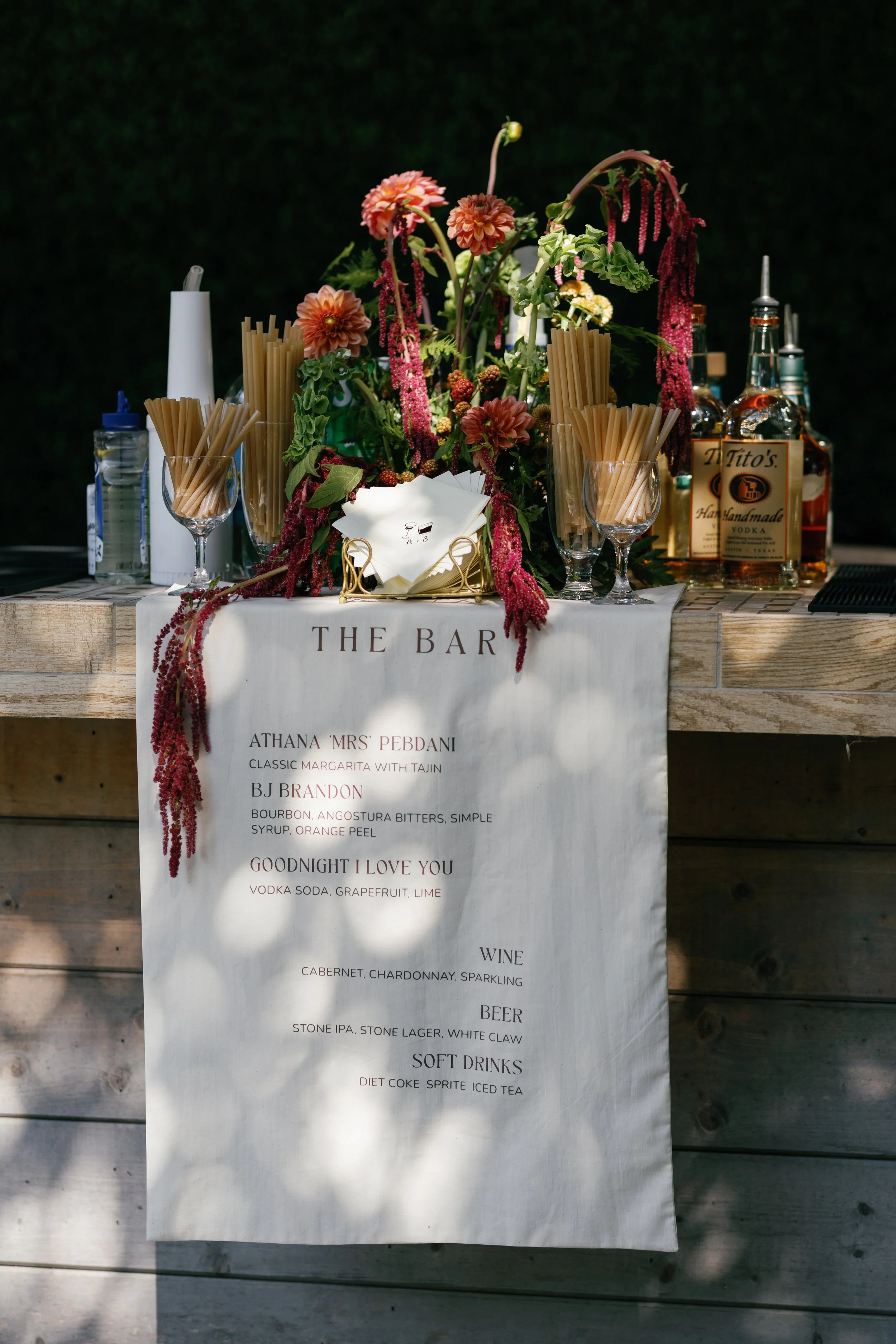linen bar signage with red and green florals