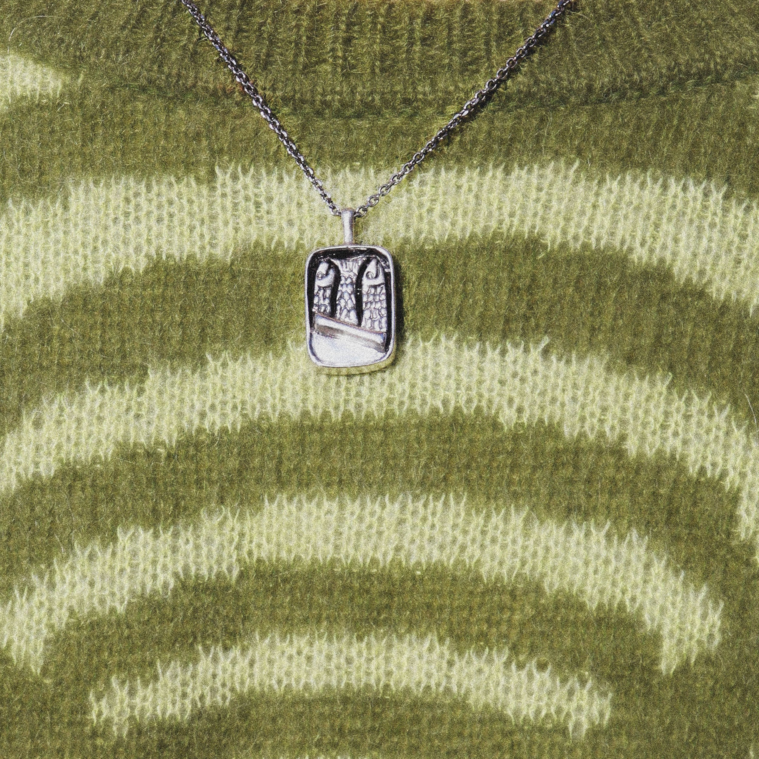(SMALL)SardinePendantCloseUpOnSweater.jpeg