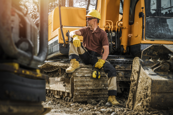 man posing with excavator