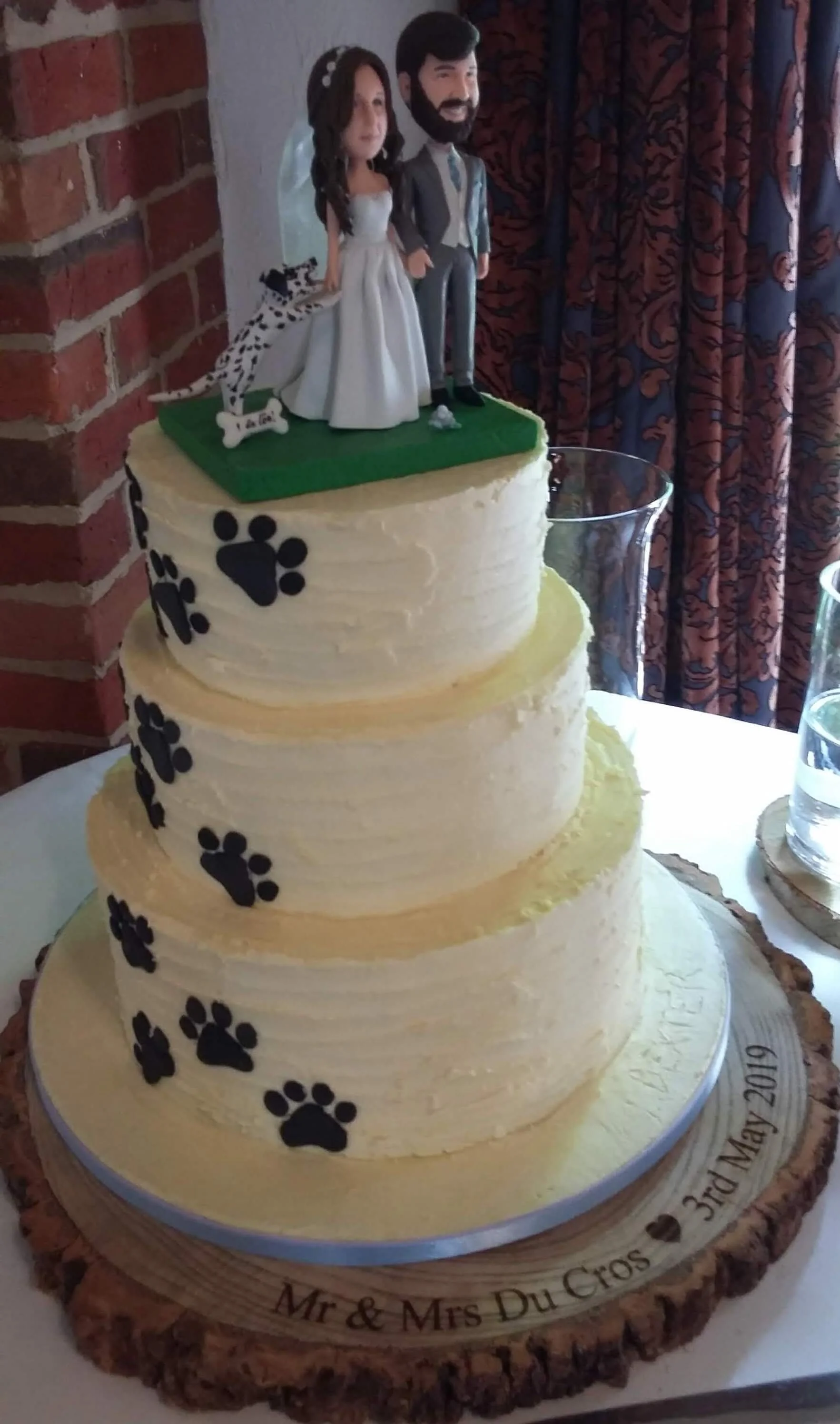 Wedding cake finished with buttercream and a speciality pet themed topper