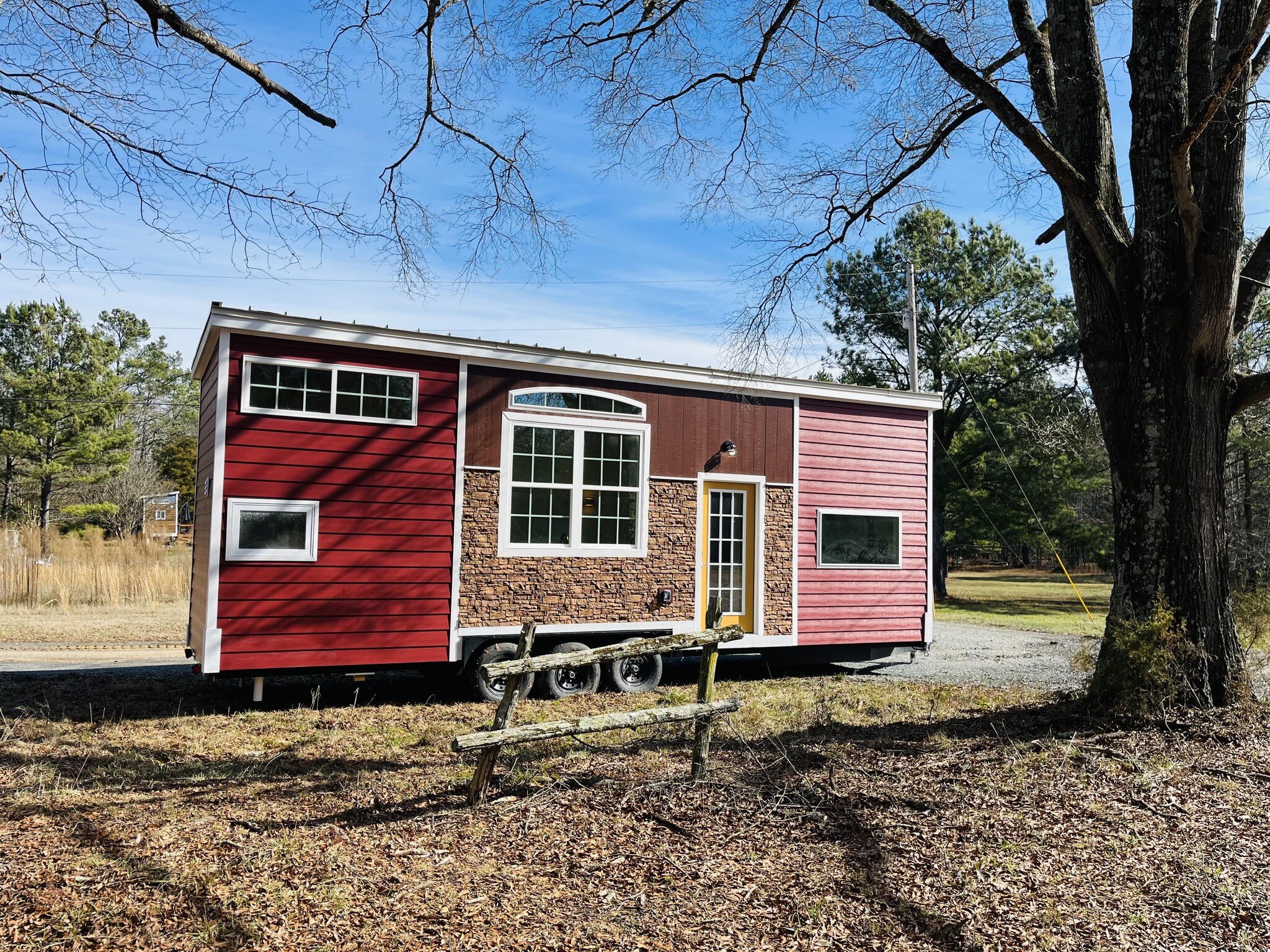 TINY HOME SPOTLIGHT: Big Red 32'

This home will not last long! Featuring custom tile work, exposed wood accents, and gold undertones, this home creates the perfect space to enjoy Lake Hartwell. A spacious master bedroom and the large loft above the 
