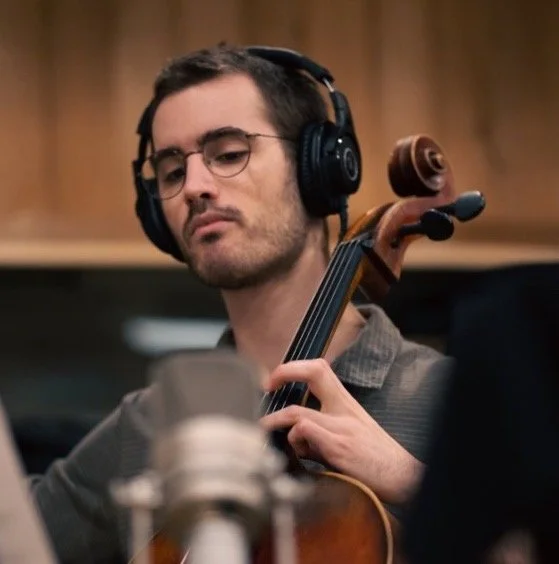 Bemjamin Roberts playing cello with headphones on