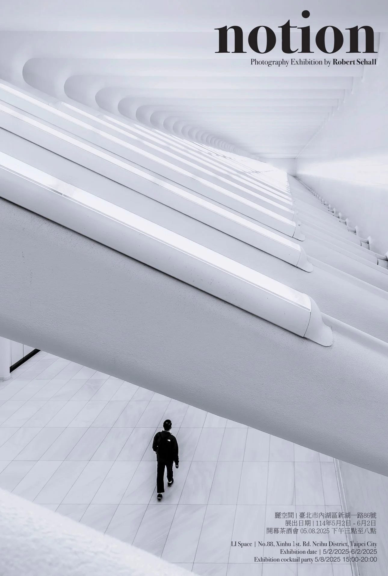 A person walking on a white tiled floor inside a modern, minimalistic building with large, white, curved architectural structures overhead. The space appears spacious and futuristic.