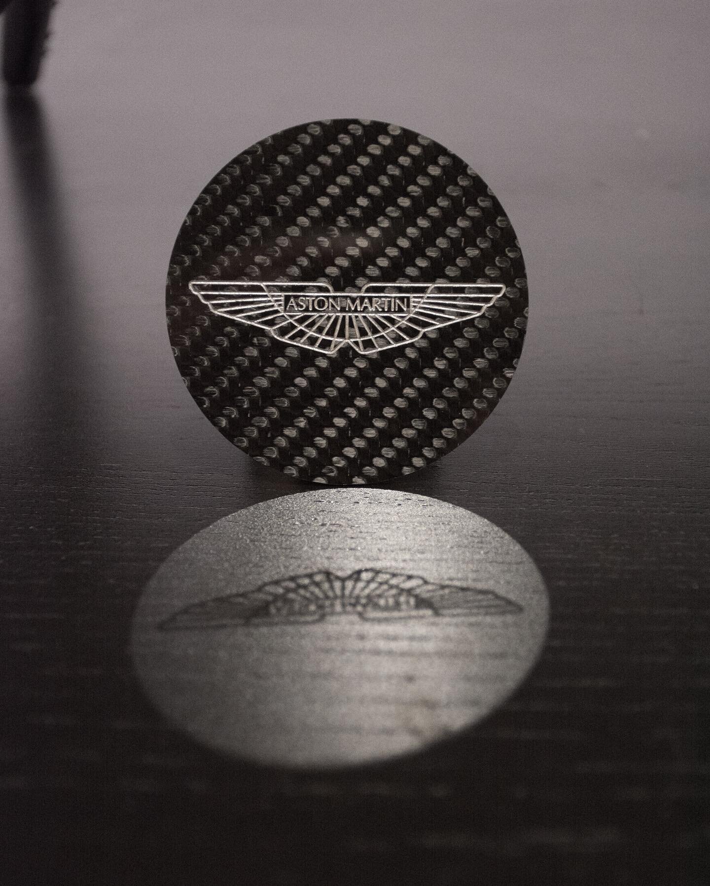 Amazing reflection ✨Aston Martin caps - Created in 1mm 2x2 3k Carbon Fiber Gloss finish - engraved and silver inkwelled! #CarbonCutUK #carbonfiber #carbonfibre #carbon #astonmartin #astonmartinvantage #vantage