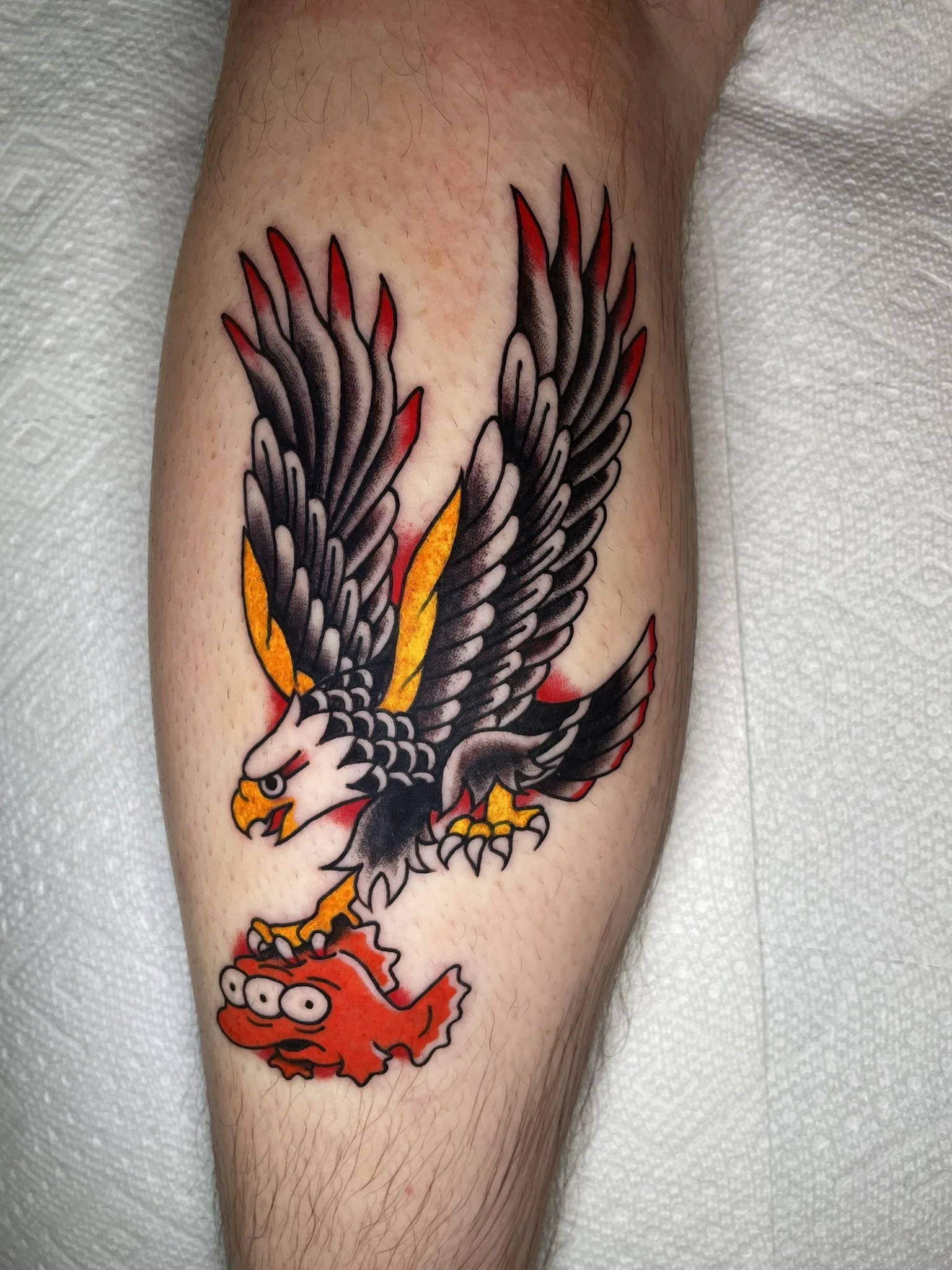 A traditional style eagle carrying a Simpsons style 3-eyed mutant fish