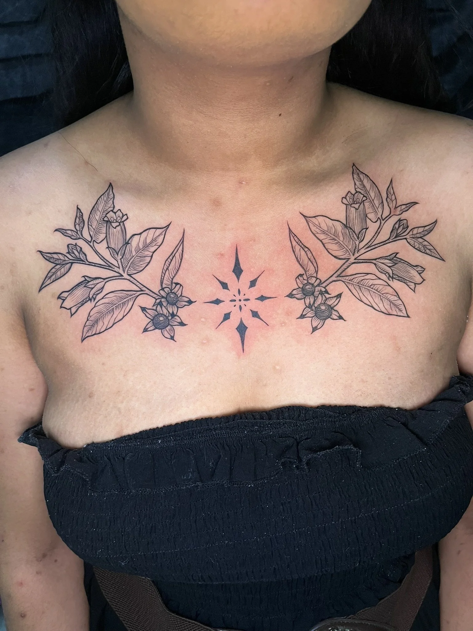Black and grey chest piece of flowers and star pieces