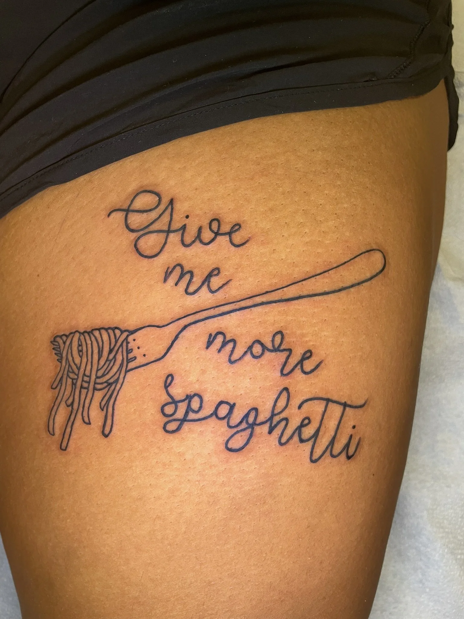 "Give me more spaghetti" in script with a fork and spaghetti wrapped around it