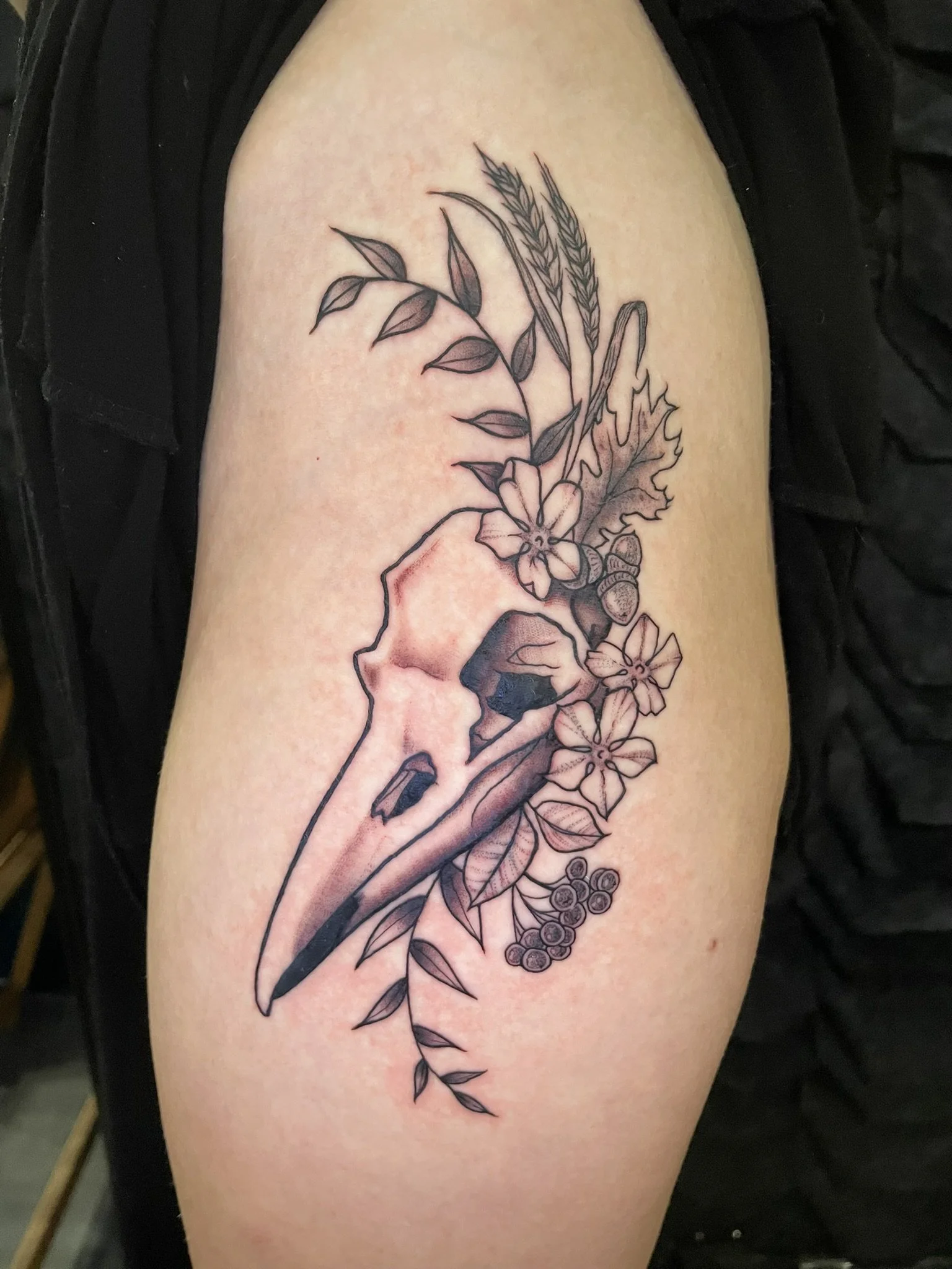 Black and grey bird skull with floral adornments