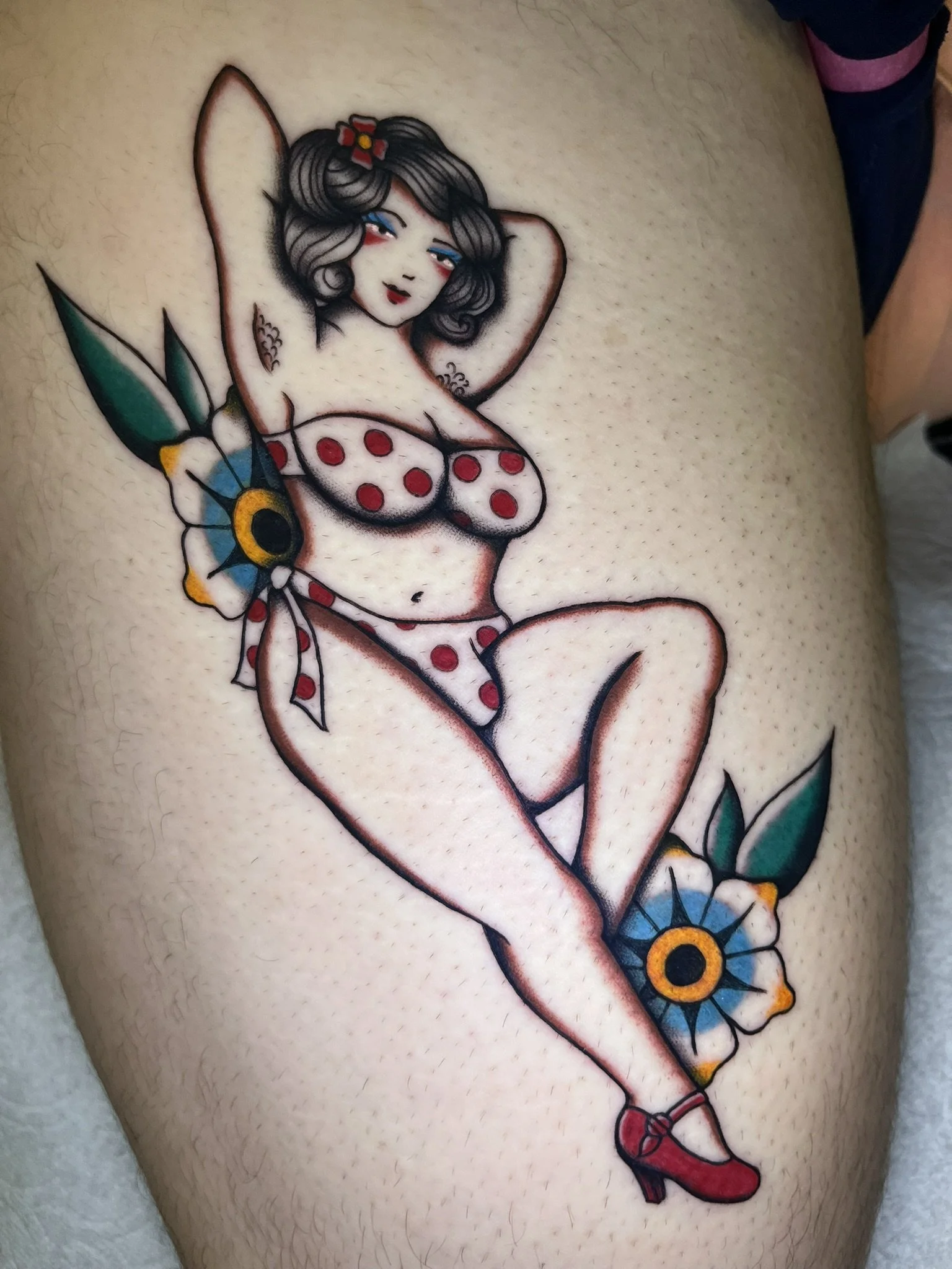 A femme woman with large chest, and a special something in her bikini bottom, with hairy armpits and traditional forget-me-not flowers