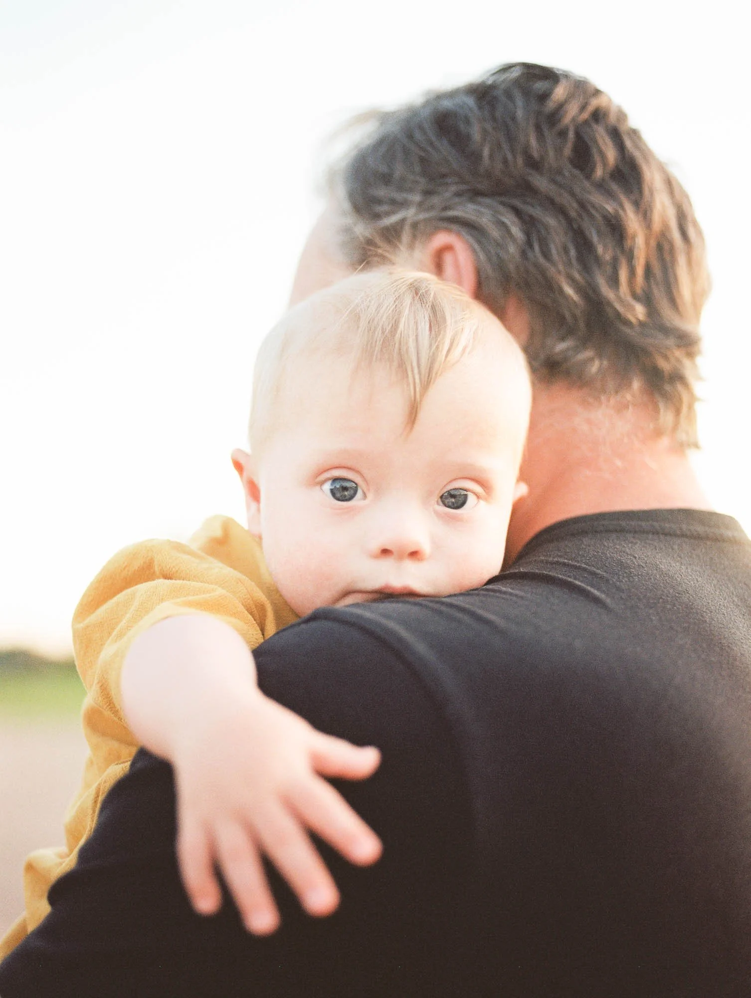 Homepage portfolio of images by San Diego family photographer Alison Hatch taken on analog film of different clients in their homes or in outdoor locations.