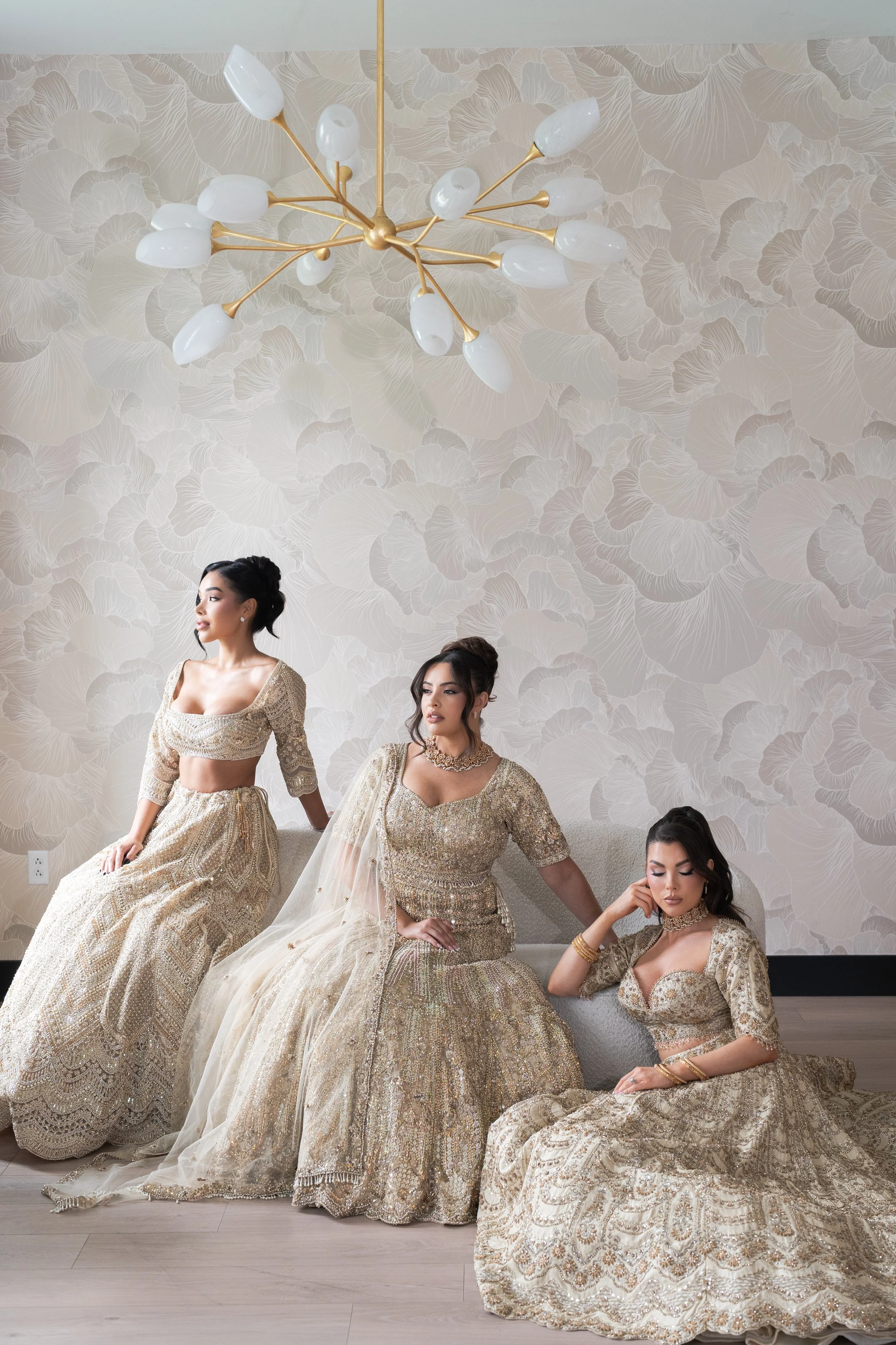 A bride with makeup and a veil, wearing a white dress with lace details.