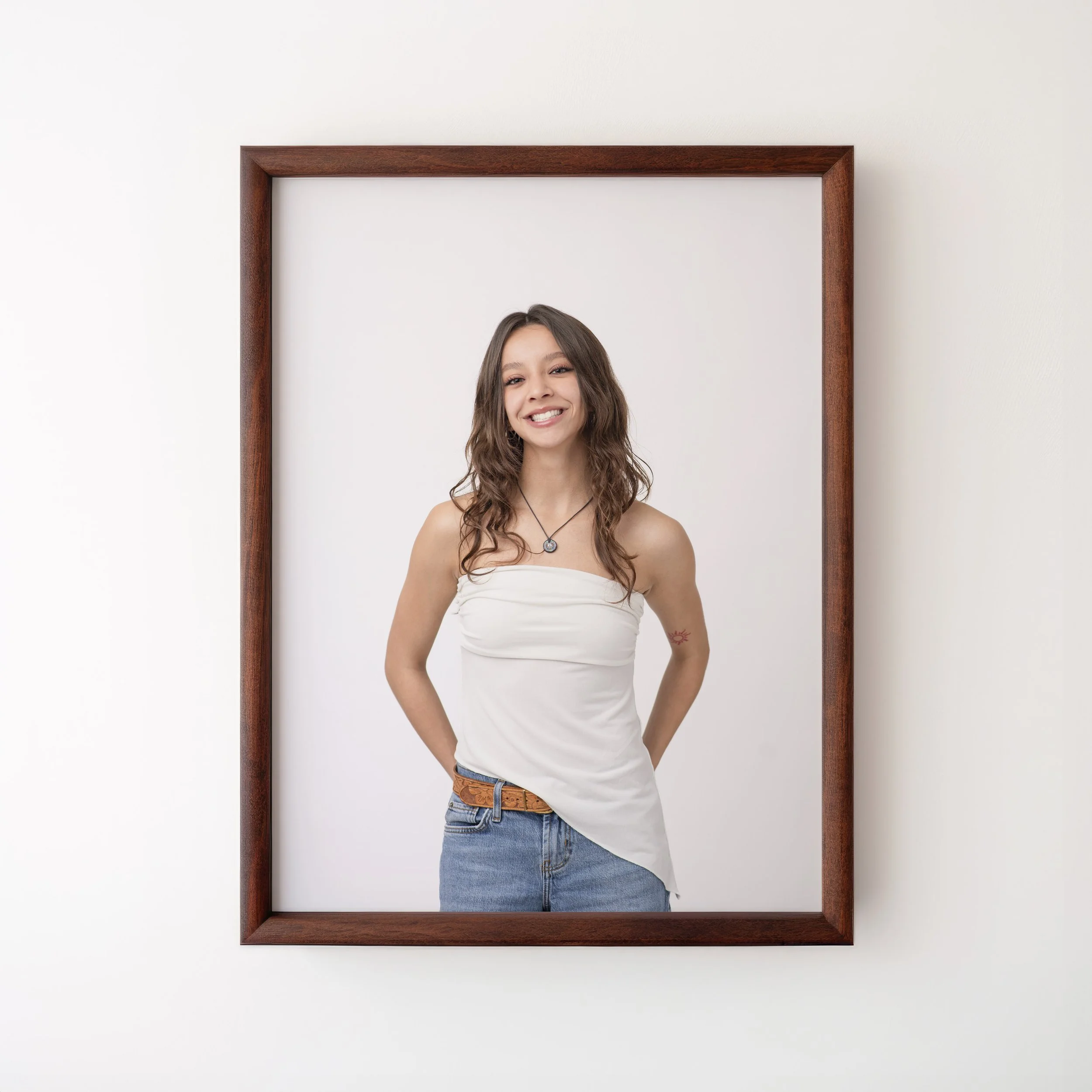 Framed portrait of high school senior in white asymetrical top and jeans