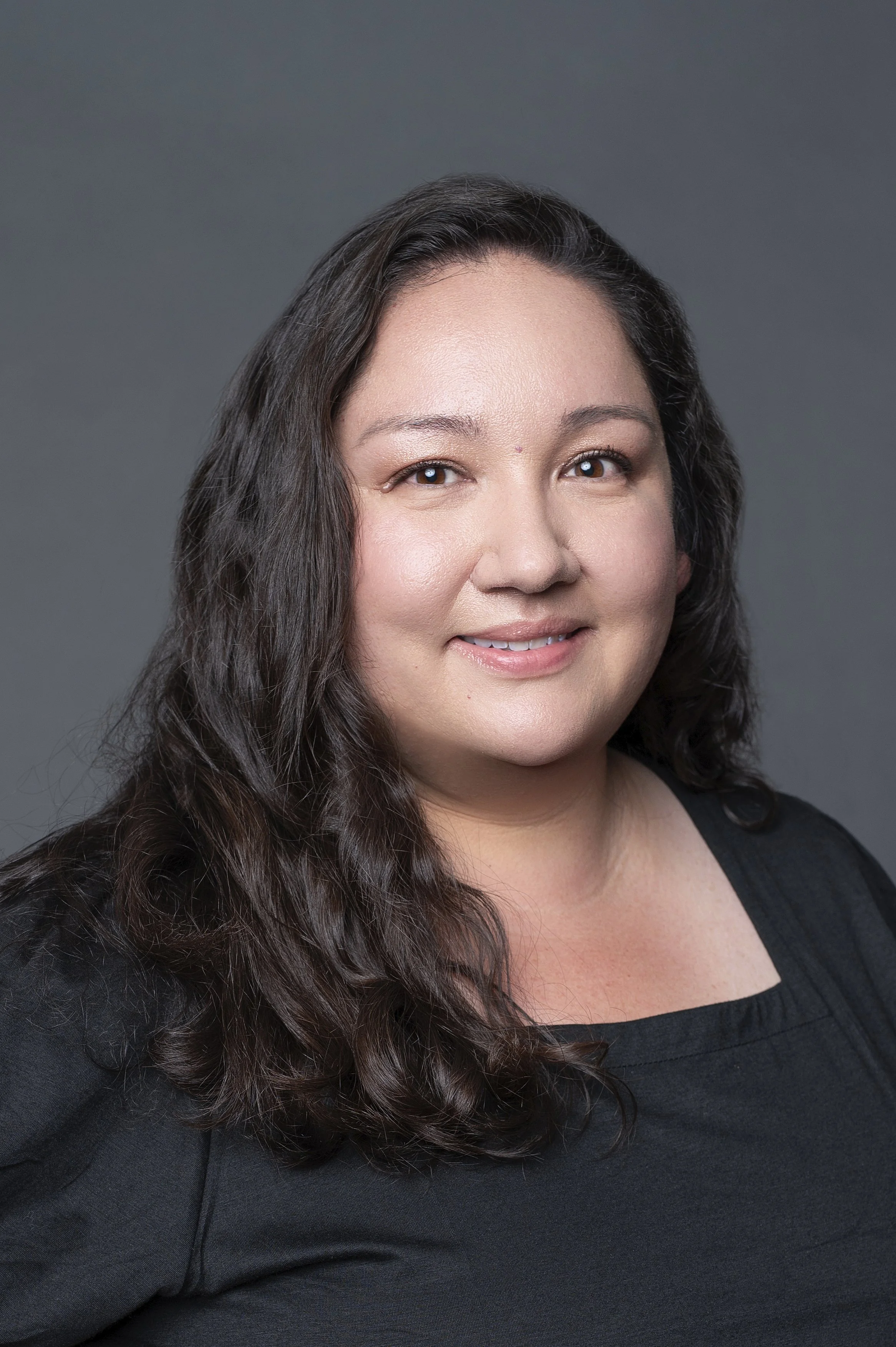 Headshot of brunette women in black top