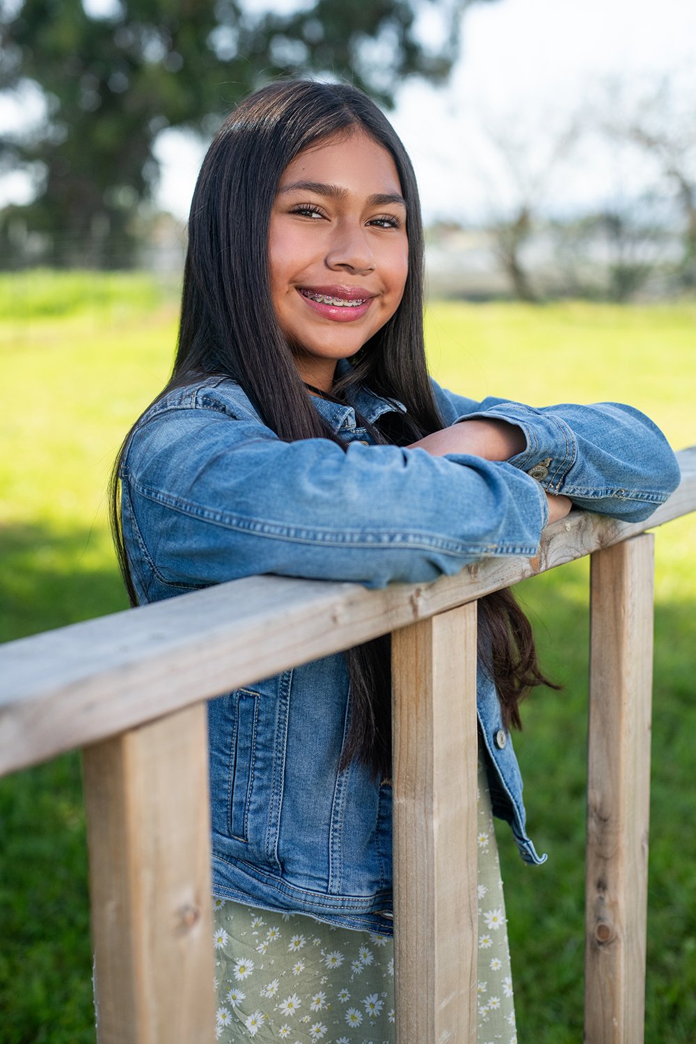 student with long dark hair in denim jacket
