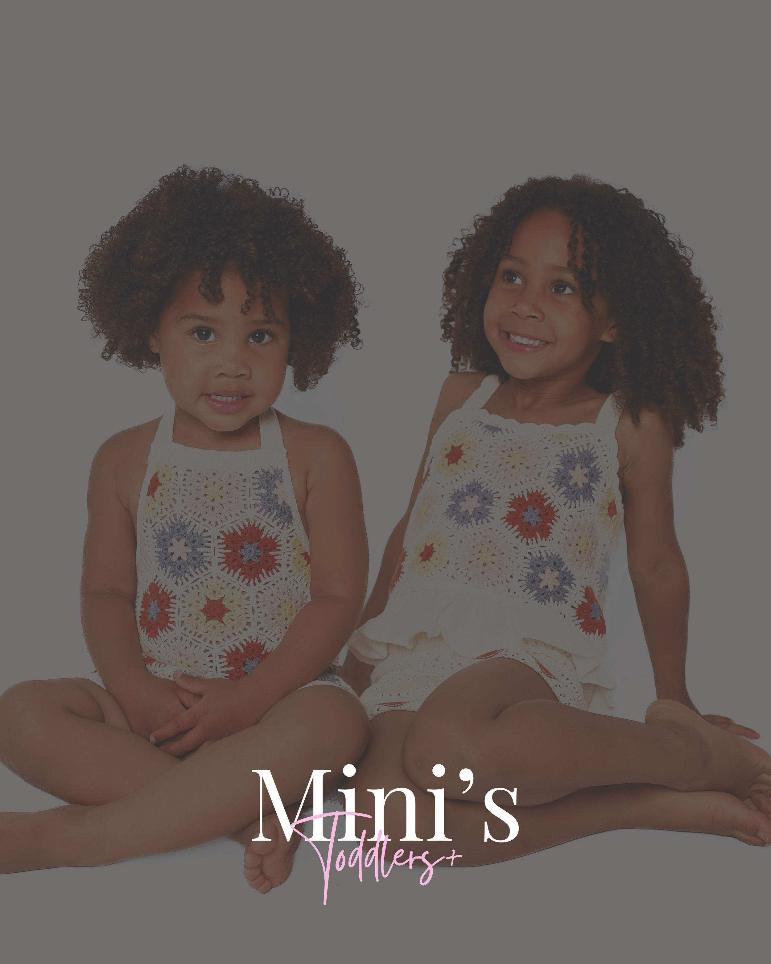 Two young girls with curly hair sitting cross-legged and smiling, wearing matching crochet tops with colorful flower patterns, against a plain white background, with the text "Mini'stoddlers+" at the bottom.