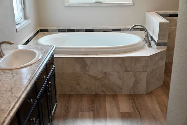 Tub deck with tile design flowing around it.