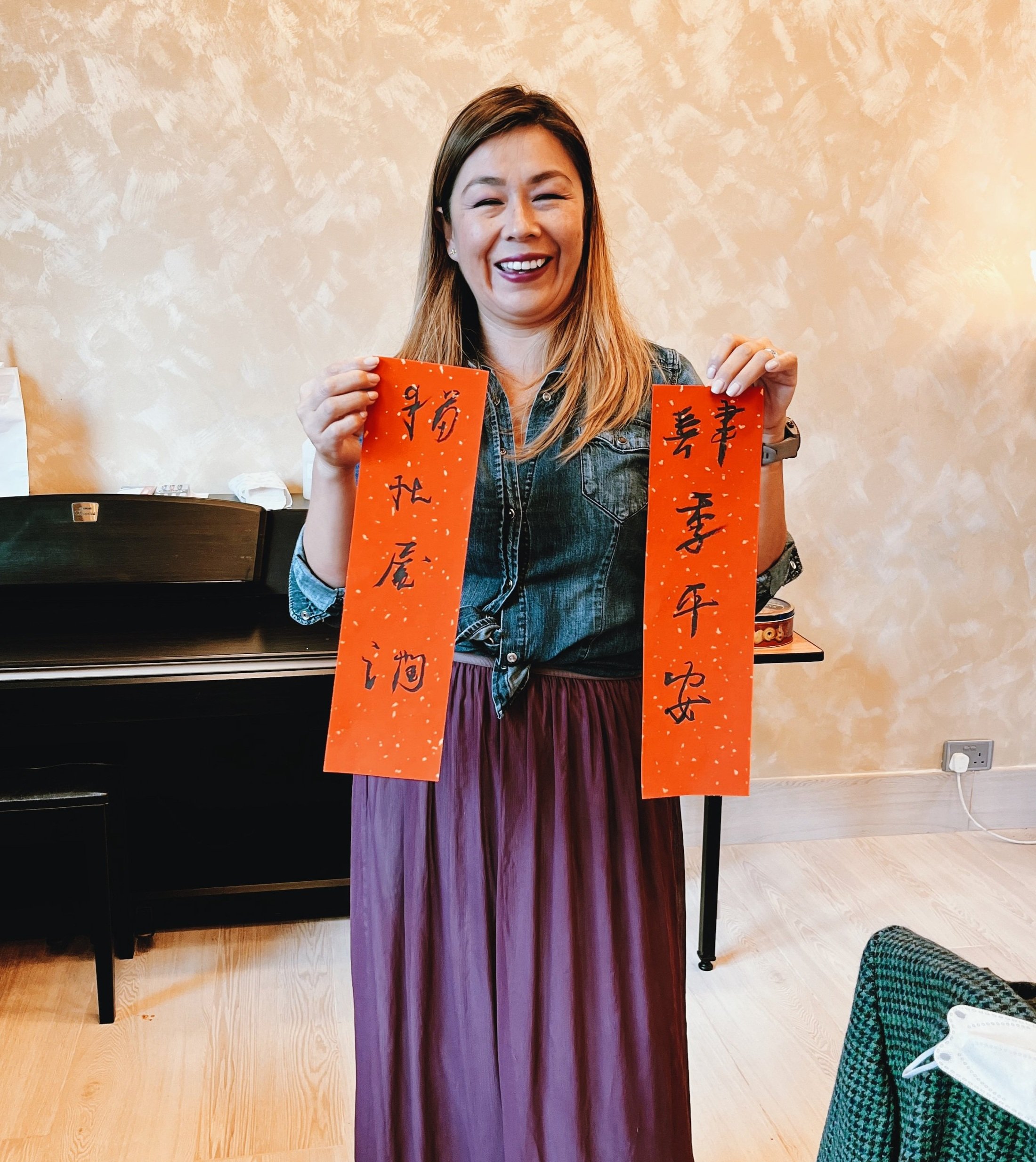 A student holding chinese calligraphy Fai Chun