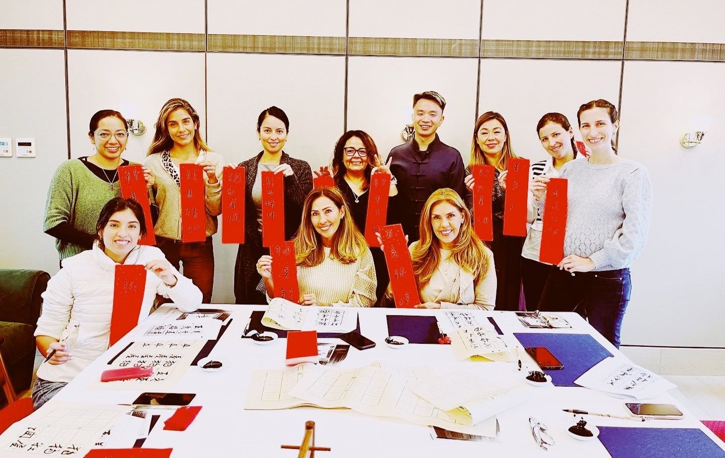A group of people holding Chinese Fai Chun in Chinese calligraphy