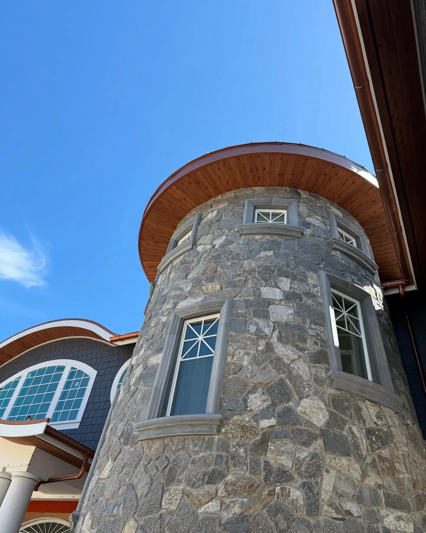 Custom precast window surrounds with sills, designed and crafted specifically for this curved stone tower. Every piece was tailored to match the architectural flow and enhance the overall character of the home.

#PrecastStone #CustomSurrounds #Archit