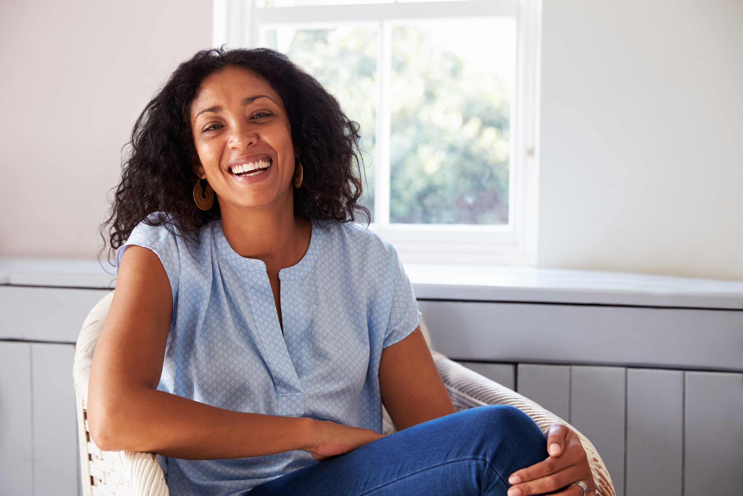 Woman with bright white smile showing Pure White  teeth whitening results