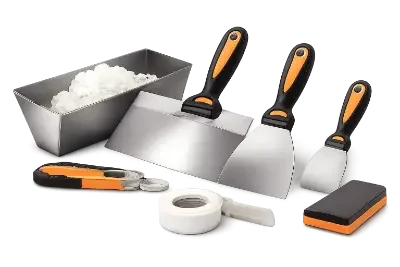 Professional tile tools set with scrapers, trowels, a small container of grout, tape, and a sponge.